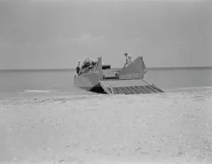 Unloading: Marines prepare to set a truck ashore from