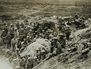 Compiled: A Mark I tank surrounded by troops of 122nd Brigade