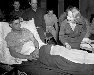 Mcfarland: Marlene Dietrich, autographs the cast on the leg