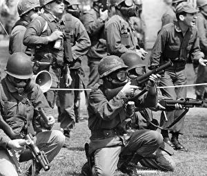 Dissipated: Masked national guardsmen fire barrage of ?