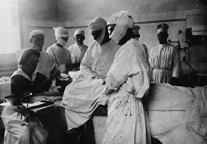 Sedation: Masked surgeons perform an operation while ?