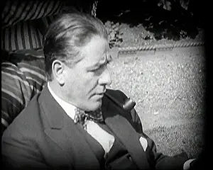 Matheson: Matheson Lang Relaxing in a Deck Chair Smoking a Pipe