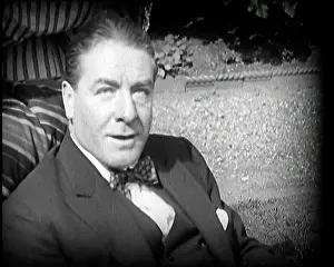 Matheson: Matheson Lang Relaxing in a Deck Chair Smoking a Pipe