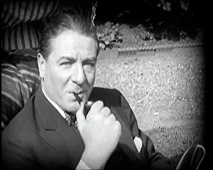 Matheson: Matheson Lang Relaxing in a Deck Chair Smoking a Pipe