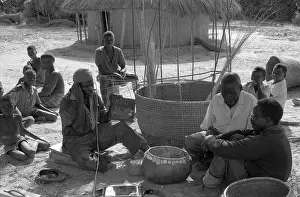 Mbira: Mbira player and constructing a large grain basket