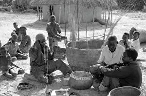 Mbira: Mbira player and constructing a large grain basket