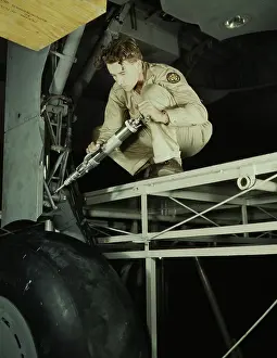 Worth: A mechanic greasing the landing gear of a