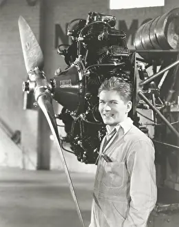 Coveralls: Mechanic standing next to propeller