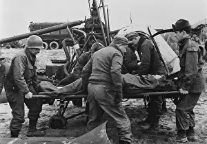 Medical Care: Medics carry a wounded U.S. soldier away from a