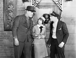 Worrisome: Two men in an argument with a woman in the middle