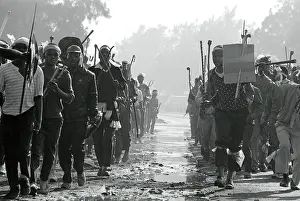 Assegais: Men, armed with traditional weapons, run in military