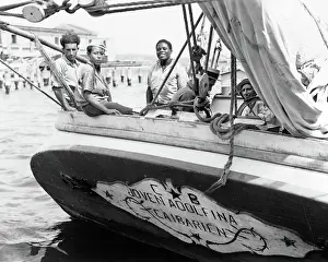 Pal001: Men and Boy at Stern of Trading Schooner Looking at Cam