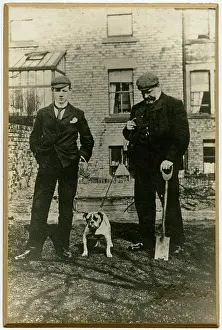 Spade: Two men with bulldog in a back garden