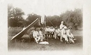 Picnicking: Men camping with two terrier dogs