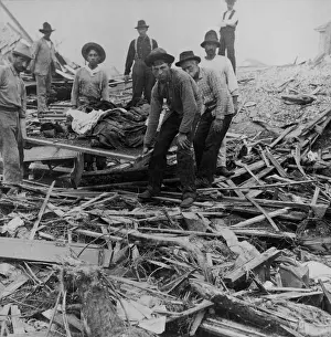 Hurricanes: Men carrying bodies on stretcher, surrounded by