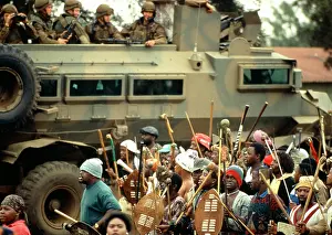 Assegais: Men carrying traditional weapons are watched by