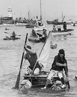 Lifejacket: Two men competing in a raft race, St Ives, Cornwall