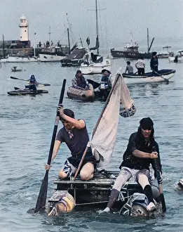 Lifejacket: Two men competing in a raft race, St Ives, Cornwall