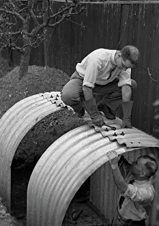 Spanner: Two men constructing an Anderson shelter
