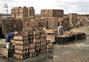 Carnie: Men with crates of fish on quayside