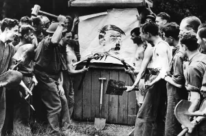 Shovels: Men destroy a Hitler illustration, 1939