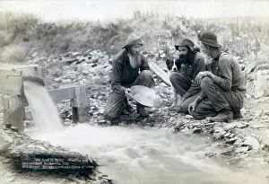 Panning: Three men, with dog, panning for gold in ?