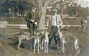Whippet: Two men with five dogs in a garden