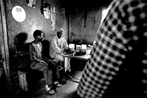 Migrate: Men drinking beer in a shebeen in Dobsonville