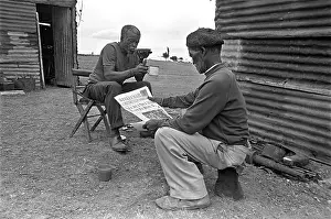 Neighbourhoods: Men drinking tea and reading The Weekly Mail. The