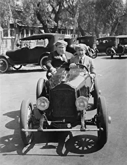 Endure: Two men driving a veteran car