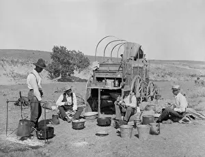 Lcgr1803: Four men eating at a chuck wagon on a Texas