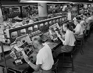 Wiring: Men in electronics factory working on television