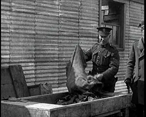 Emptying: Men Emptying Salvaged Items Into A Large Container