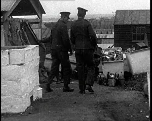 Emptying: Men Emptying Salvaged Items Into A Large Container