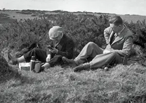 Thermos: Two men enjoying a hilltop picnic
