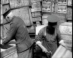 Hammering: Men Hammering Together Wooden Boxes