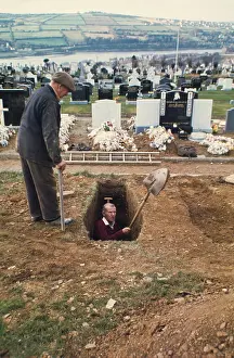 Cemetry: Men hand digging a grave