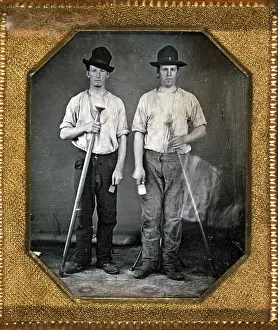 Molds: Two men holding floor rammers, foundry tools ?