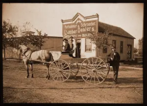 Storefront: Men with a horse and buggyn front of a lumber store