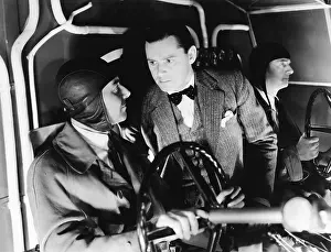 Copilot: Three men inside of the cockpit of an airplane