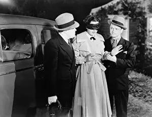 Helpless: Men leading blindfolded woman