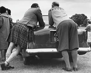 Socks: Two men leaning on a car