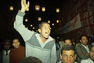 1987egypt: Men listening to a speech at a rally for ?
