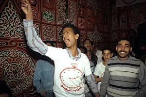 1987egypt: Men listening to a speech at a rally for ?