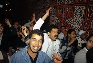 1987egypt: Men listening to a speech at a rally for ?