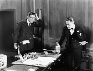 Seriousness: Two men looking surprised in an office