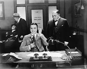Employ: Men at an office one on the telephone