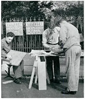 Phony: Men painting warning signs for unexploded bombs, Sept 1939