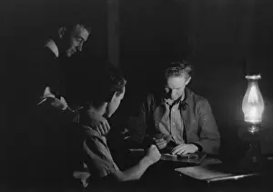 Kerosene: Men play cards by the light of a kerosene ?