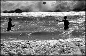 Surf: Men playing with a ball in heavy surf